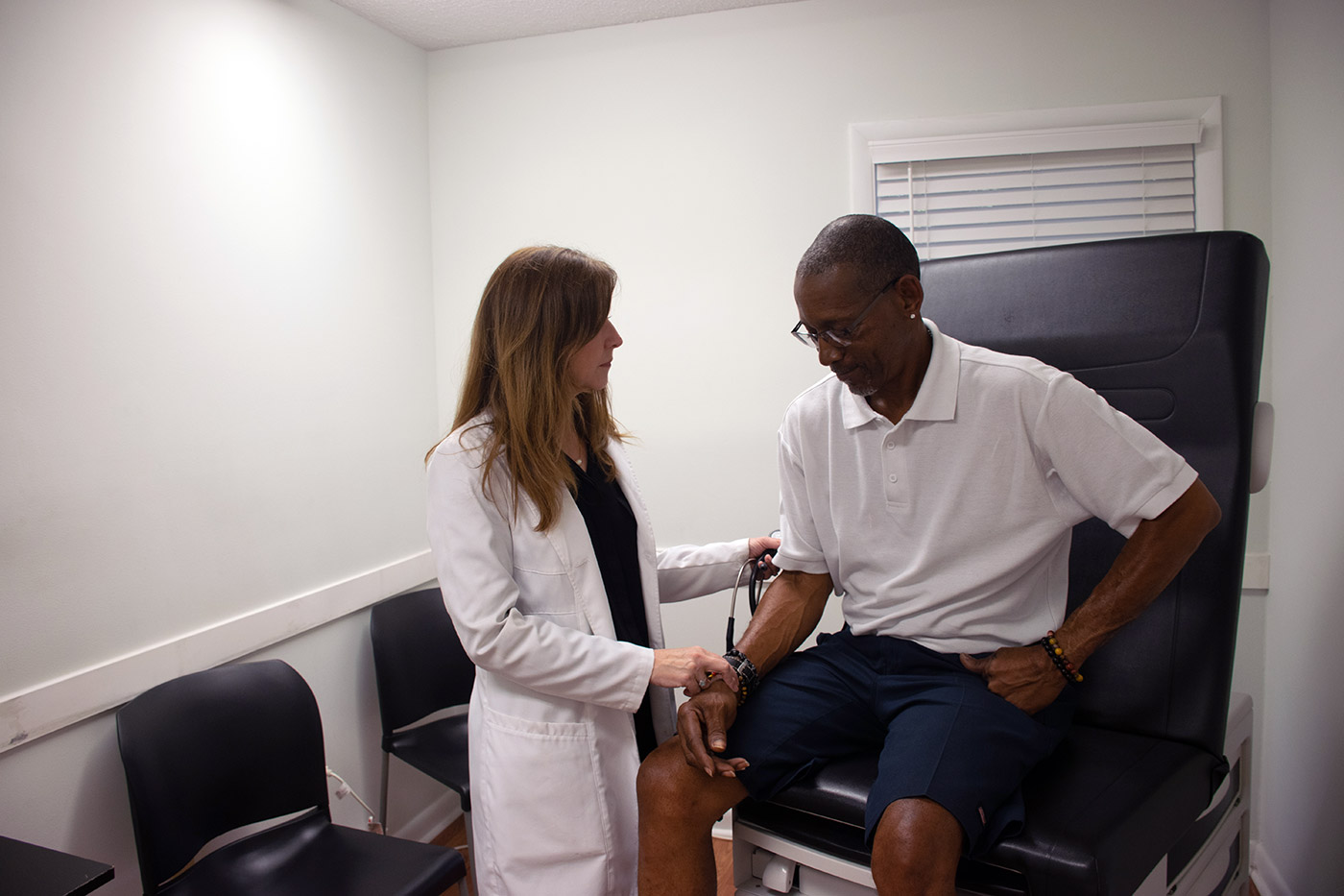 Doctor tests patient's blood pressure